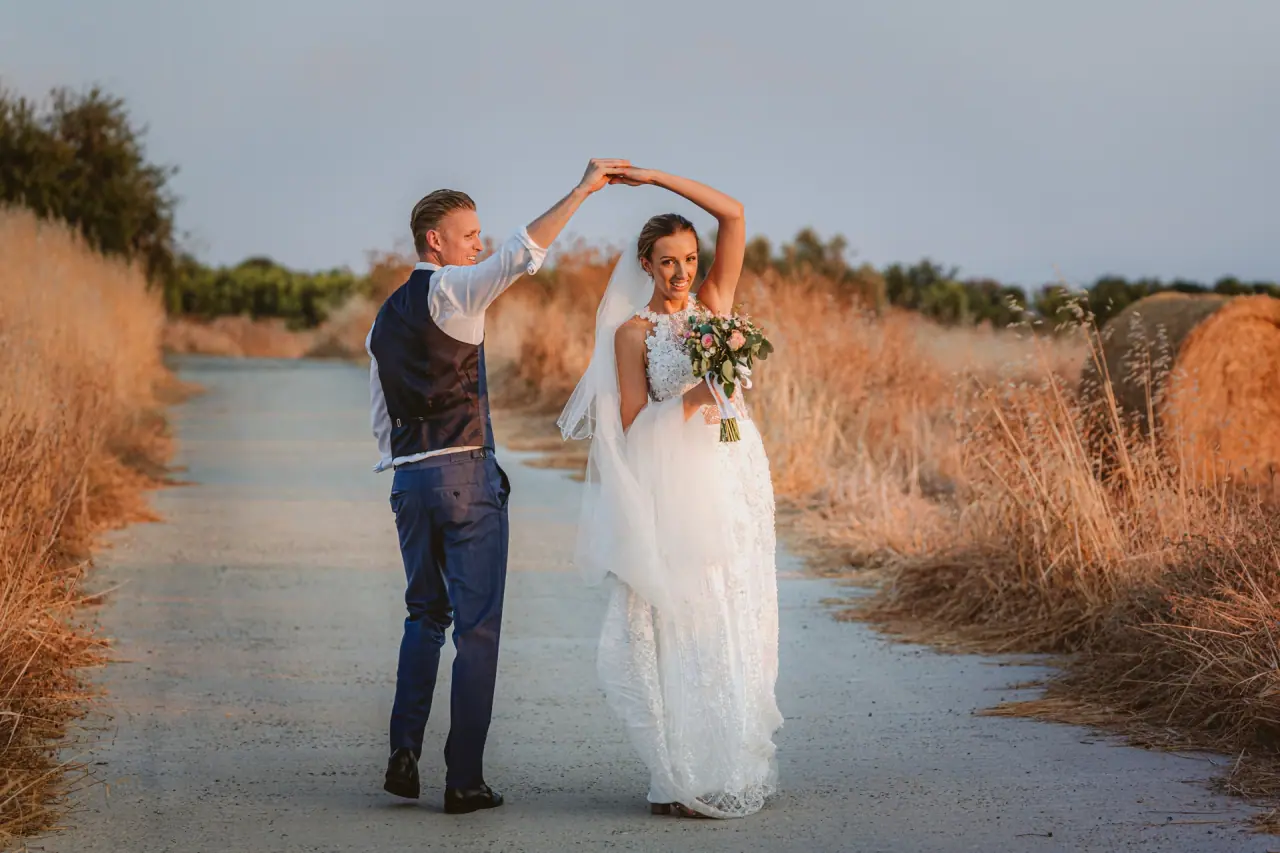 Charlene and Ben twirling on a country lane through dry grasses, Liopetro, Kouklia