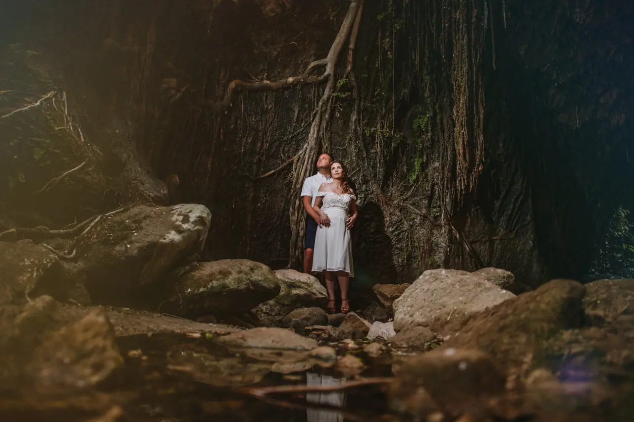 Kim and Craig in wedding attire standing in a rocky, tree-lined Akamas gorge