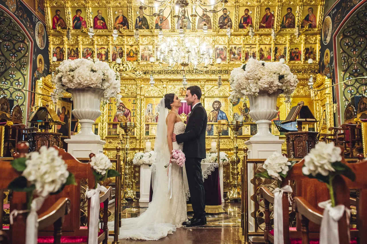 Ruby and Angelos at the altar of an ornate gold Greek Orthodox church, Nicosia