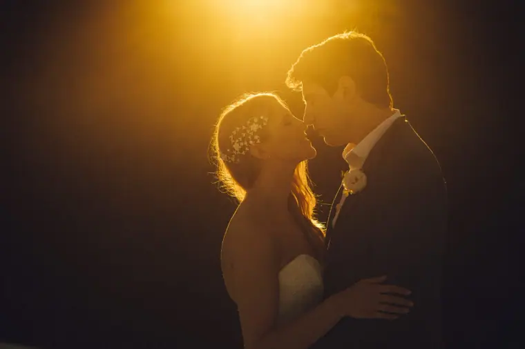 Bride and groom kissing, backlit by warm golden light, at Elixir, Ibiza