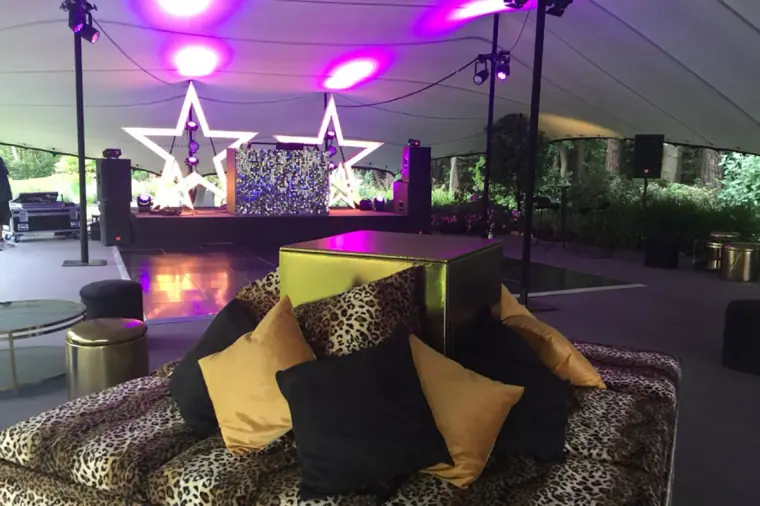 Reception marquee with leopard-print lounge, dancefloor and illuminated star decorations, Ibiza
