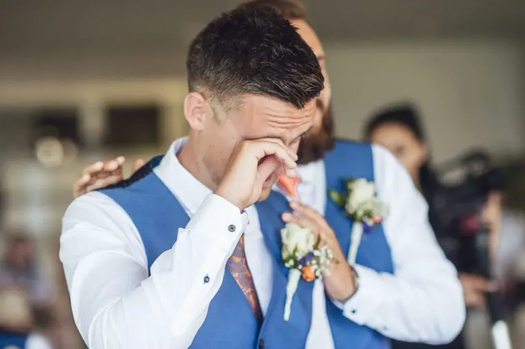 Groom in a blue waistcoat wiping away a tear in Ayia Napa