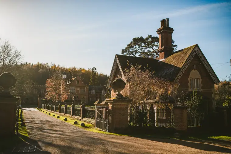 Victorian gatehouse and tree-lined drive at Wotton House in low winter sun