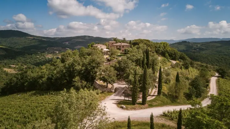 Aerial view of rolling Tuscan hills and cypress trees around Livernano Estate