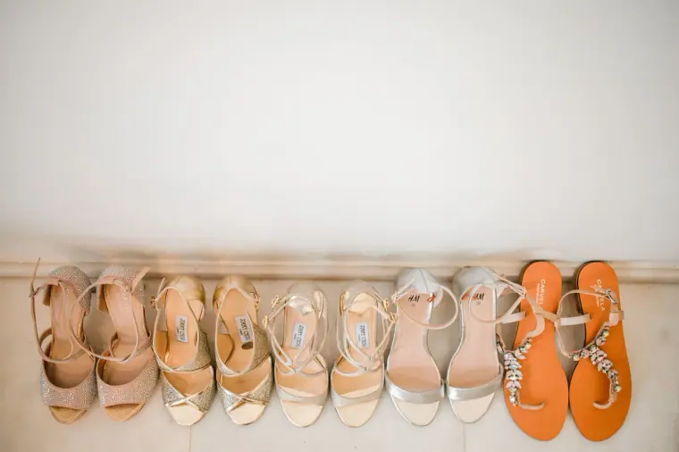 Row of bridal and bridesmaid sandals lined up against a white wall, Almyra, Paphos