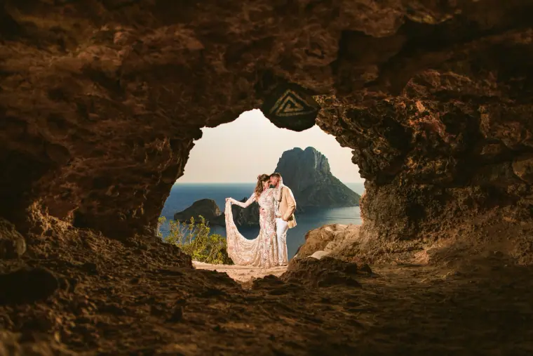Kenton and Hassiba in a cave arch overlooking the sea and Es Vedrà, Ibiza