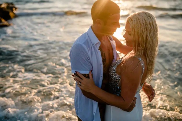 Maryellen and Ben embracing in the surf at sunset, Paphos