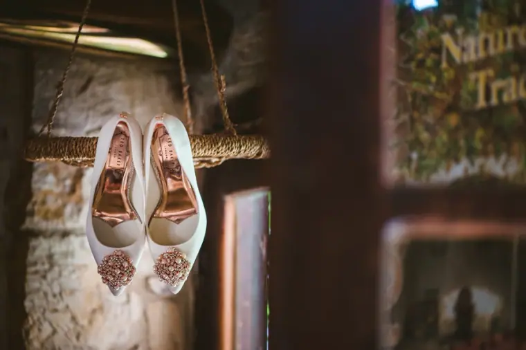 Embellished bridal shoes hanging from a stone wall at Vasilias Nikoklis Inn
