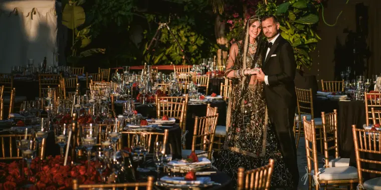 Kenton and Hassiba in evening wear beside a candlelit garden banquet at their Hollywood-Bollywood party, Ibiza