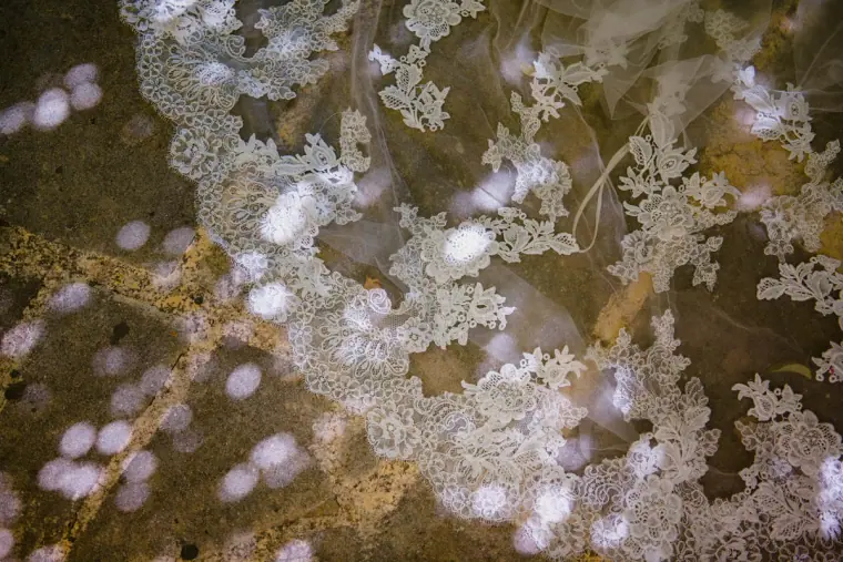 Close-up of delicate floral lace on the bride's veil