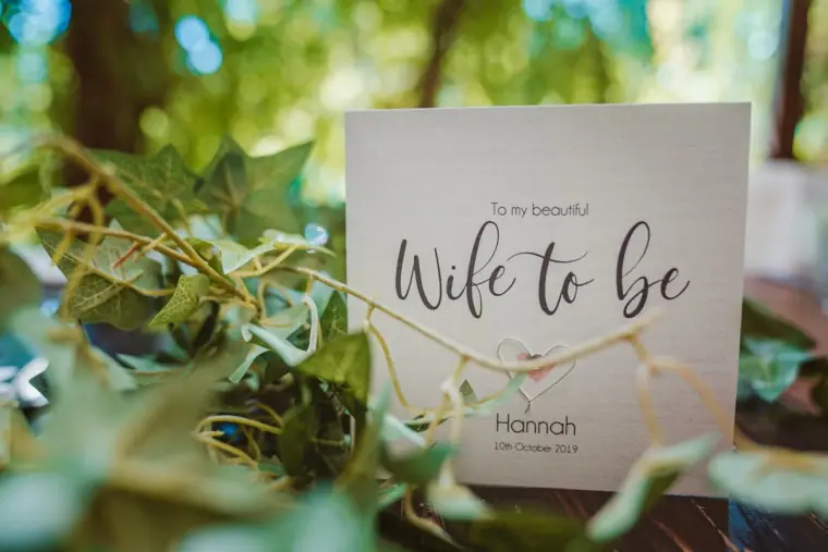 "Wife to be" card addressed to Hannah propped among ivy leaves