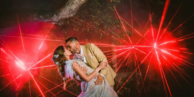 Kenton and Hassiba kissing amid red laser beams at their Kentiba Fest party, Ibiza