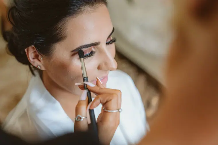 Close-up of the bride having her eye make-up applied