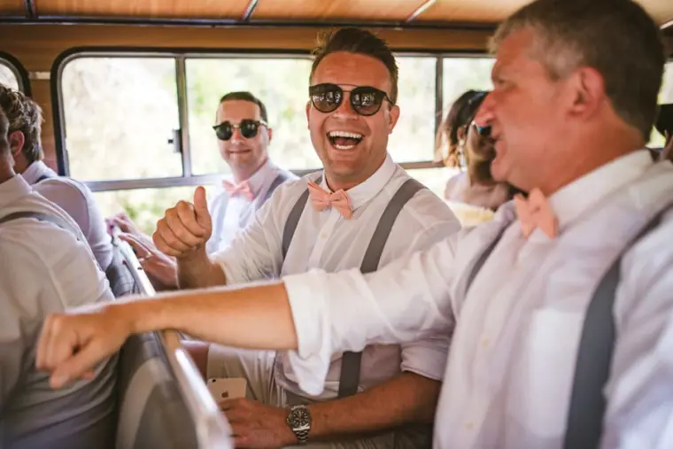 Graeme and groomsmen laughing on board the vintage wedding bus
