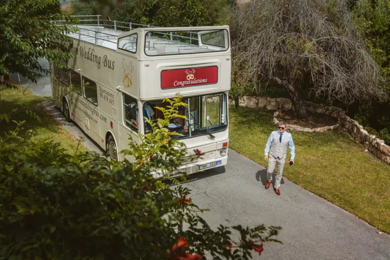 Vintage open-top double-decker wedding bus parked on the inn's driveway