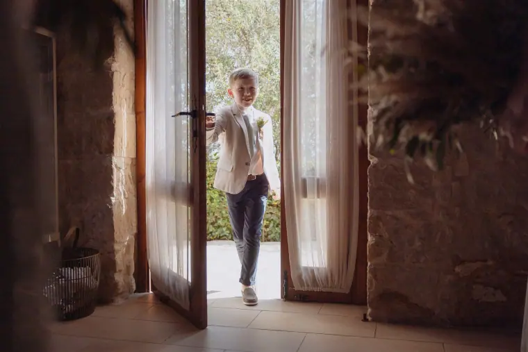 Ben stepping through tall wooden doors into the room