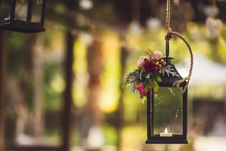 Hanging lantern decorated with red and pink flowers