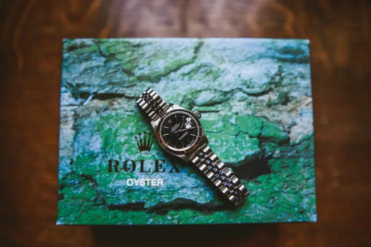 Rolex watch resting on its green Oyster box