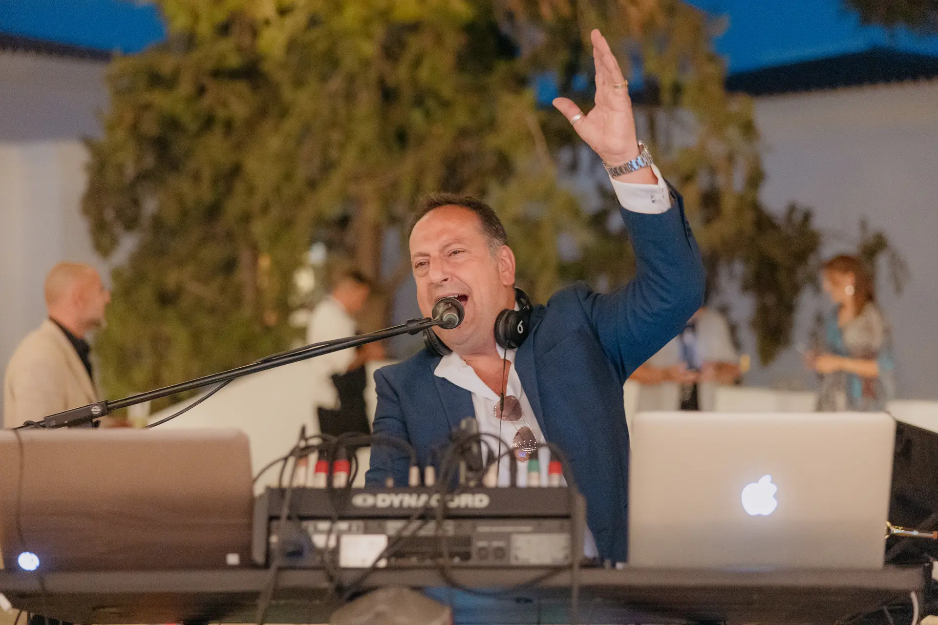 Singer at a keyboard performing with his arm raised at the evening reception