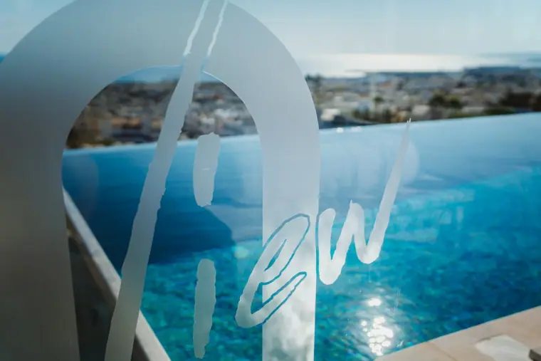 Napa Suites rooftop signage reading View, with the infinity pool and Ayia Napa coastline behind