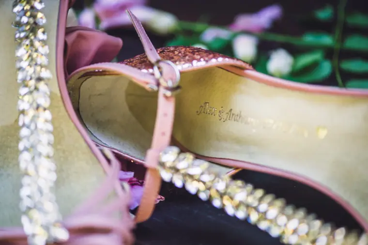 Close-up of a jewelled heel strap and the inside of a pink bridal shoe