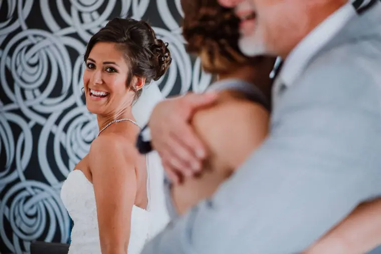 Louise hugging her father, smiling over his shoulder