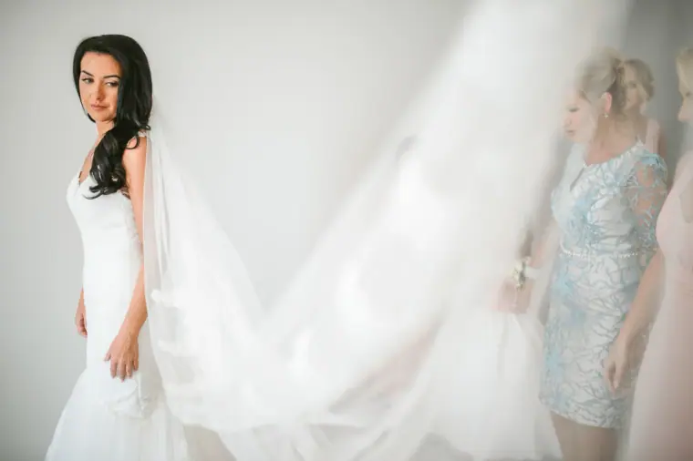 Jaclyn in her fitted gown as her long veil is spread out behind her
