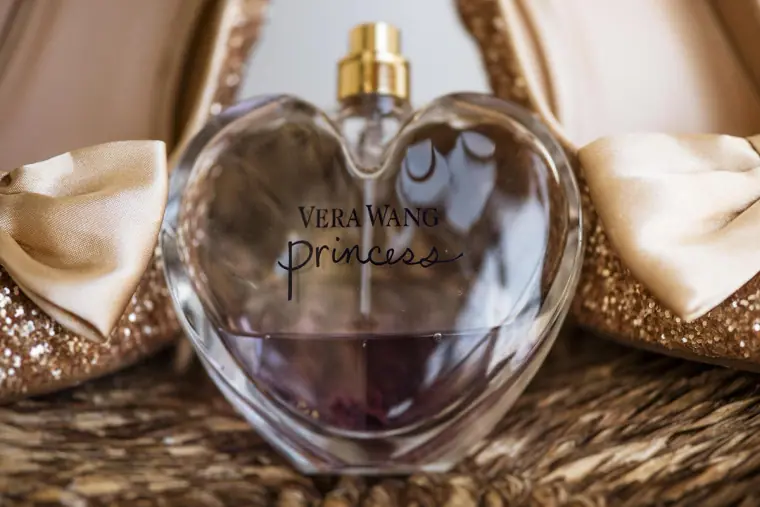 Vera Wang Princess perfume bottle between the bride's glitter heels
