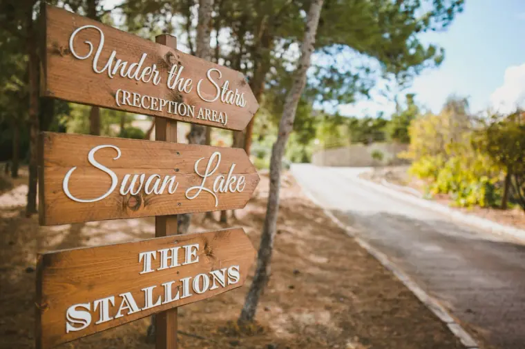 Wooden direction signs for Under the Stars, Swan Lake and The Stallions at Lexeko Estate, Cyprus
