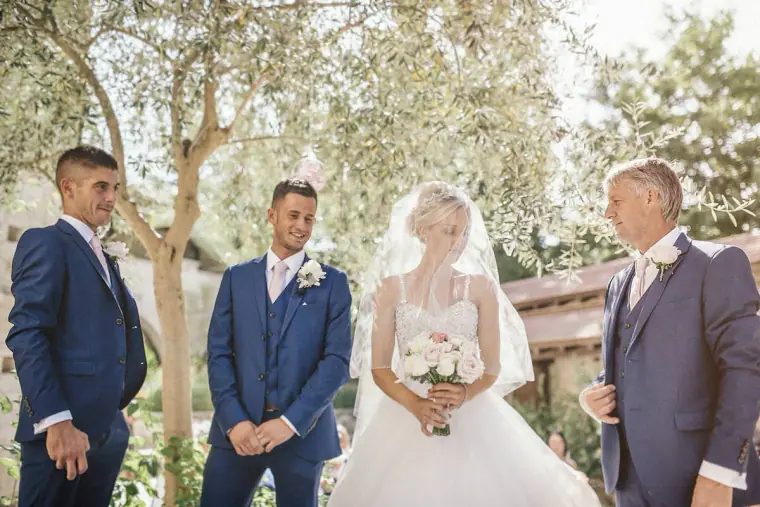 Bride holding her bouquet beside the groom at the start of the ceremony