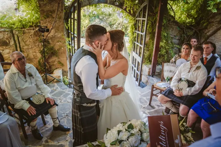 Hannah and Keith's first kiss as husband and wife, guests watching