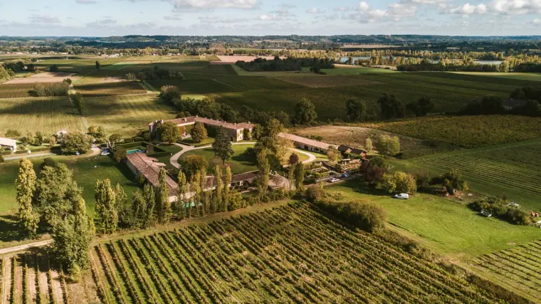 Aerial view of vineyards and a chateau estate in the Bordeaux countryside, Chateau Rigaud