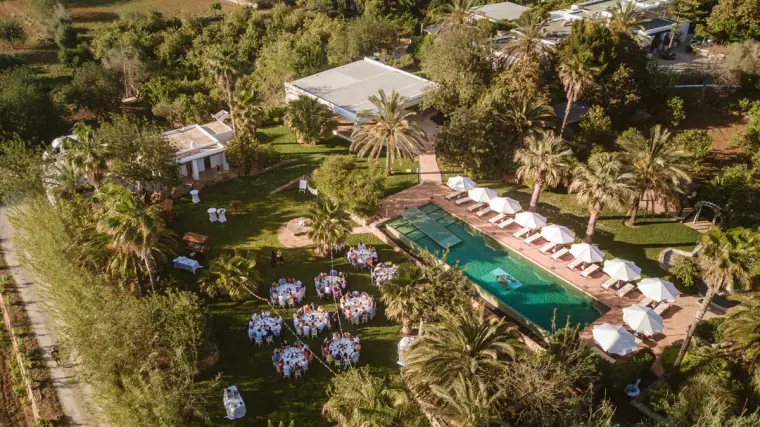 Aerial view of Can Gall's gardens, pool and reception tables set among trees