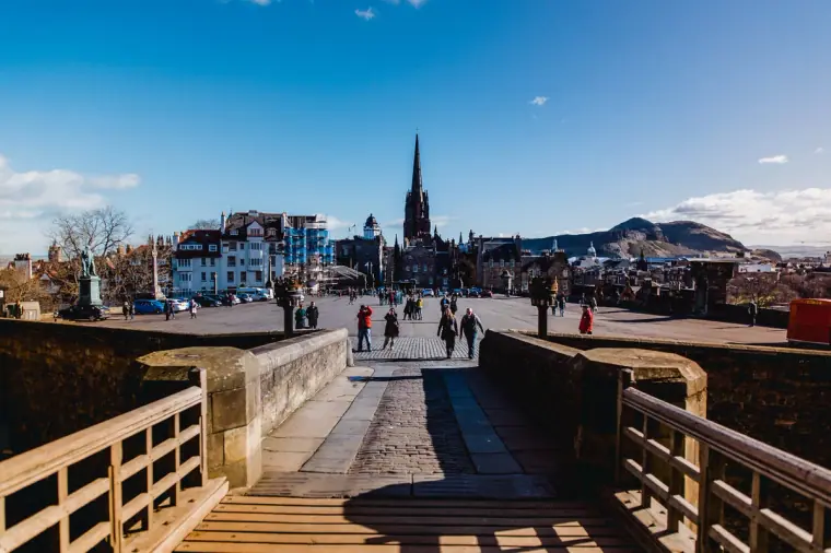 Bridge walkway leading towards the city skyline and Arthur's Seat, Edinburgh