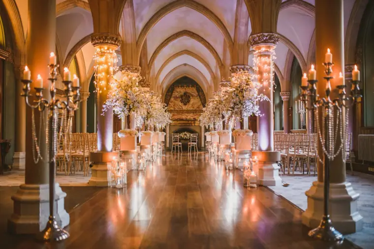 Vaulted hall at Wotton House lit by candelabras, dressed for the ceremony
