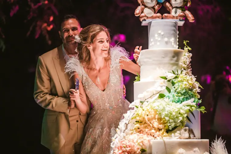 Hassiba laughing as she and Kenton cut their wedding cake