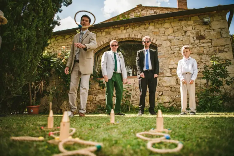 Guests playing ring toss on the lawn in front of the stone buildings at Livernano Estate