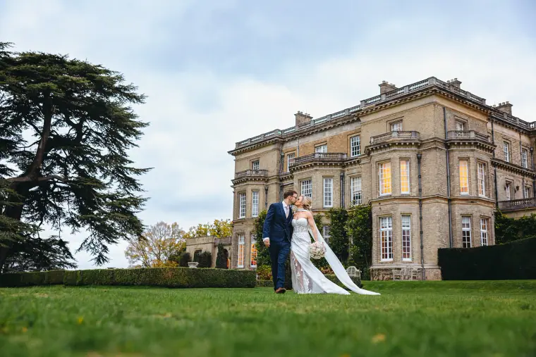 Ian and Jade embracing on the lawn in front of Hedsor House