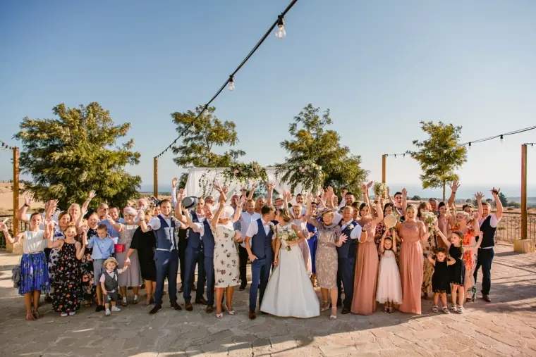 Large group photo of guests cheering on the terrace at Liopetro, Kouklia