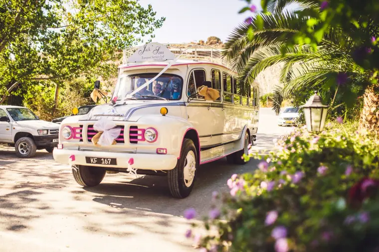 Vintage cream Bedford bus decorated with ribbons arriving at Vasilias Nikoklis Inn