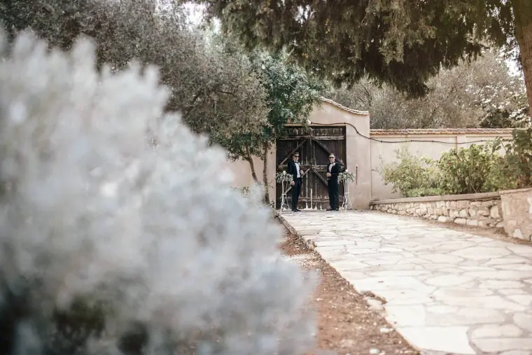 Stone path leading through a gateway in the monastery grounds, soft foliage in front