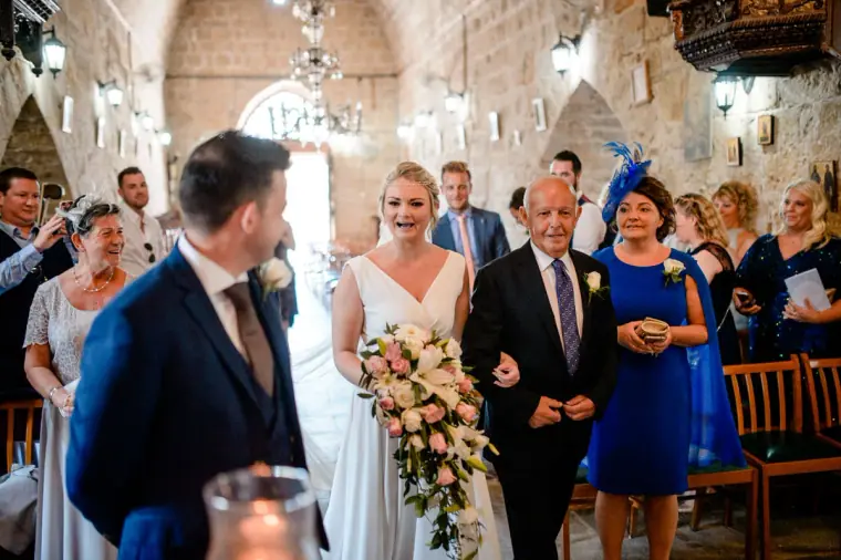 Francesca walking down the aisle with her father inside Ayia Kyriaki, Paphos