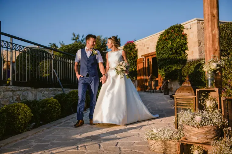 Nicola and Joel walking hand in hand along the terrace at Liopetro, Kouklia