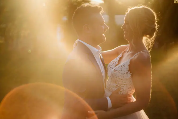 Iain and Sophie gazing at each other in a haze of golden sunset light