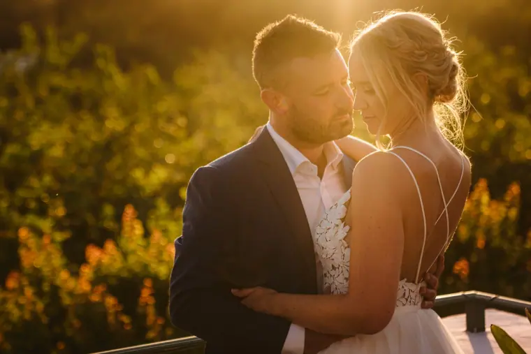 Iain holding Sophie close in warm evening light among greenery, Can Gall, Ibiza