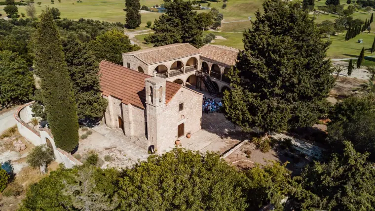 Aerial view of the old stone monastery among cypress trees at Minthis Hills