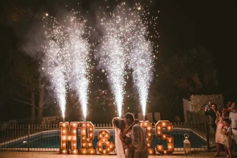 First dance by the pool between sparkler fountains and Mr & Mrs letters at Vasilias Nikoklis Inn