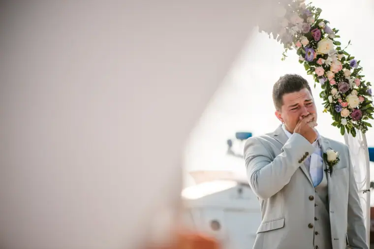 Nathan becoming emotional at the floral arch as his bride approaches