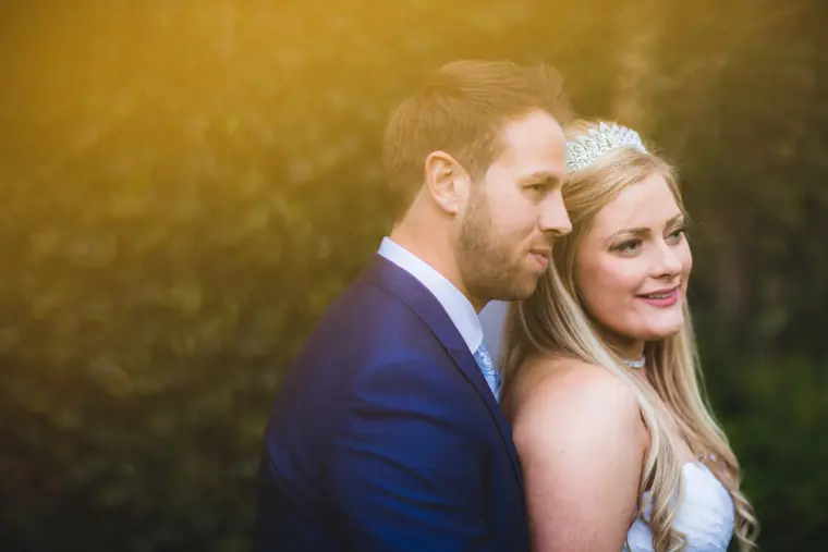 Lyndsay and Thomas cheek to cheek against a warm golden background, New Forest