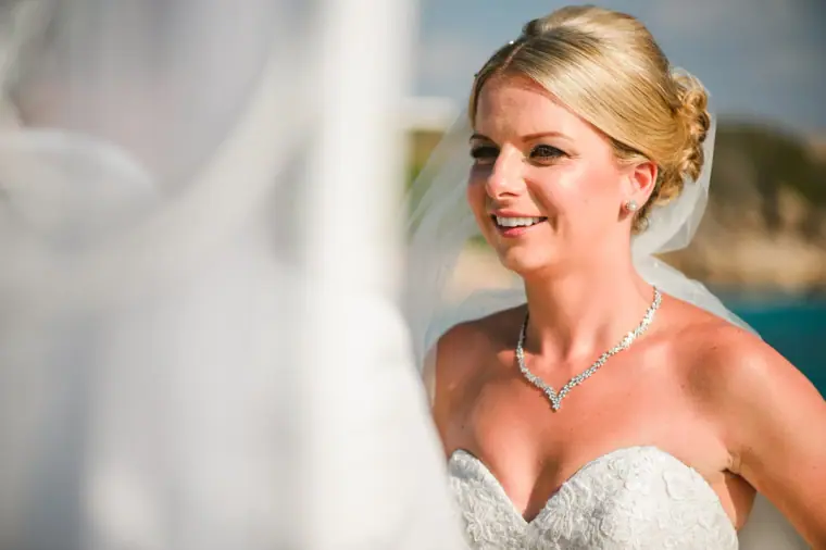 Charlotte smiling during the ceremony, framed by her veil